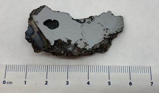A chunk of black and gray meteoric rock which contains the two brand-new minerals