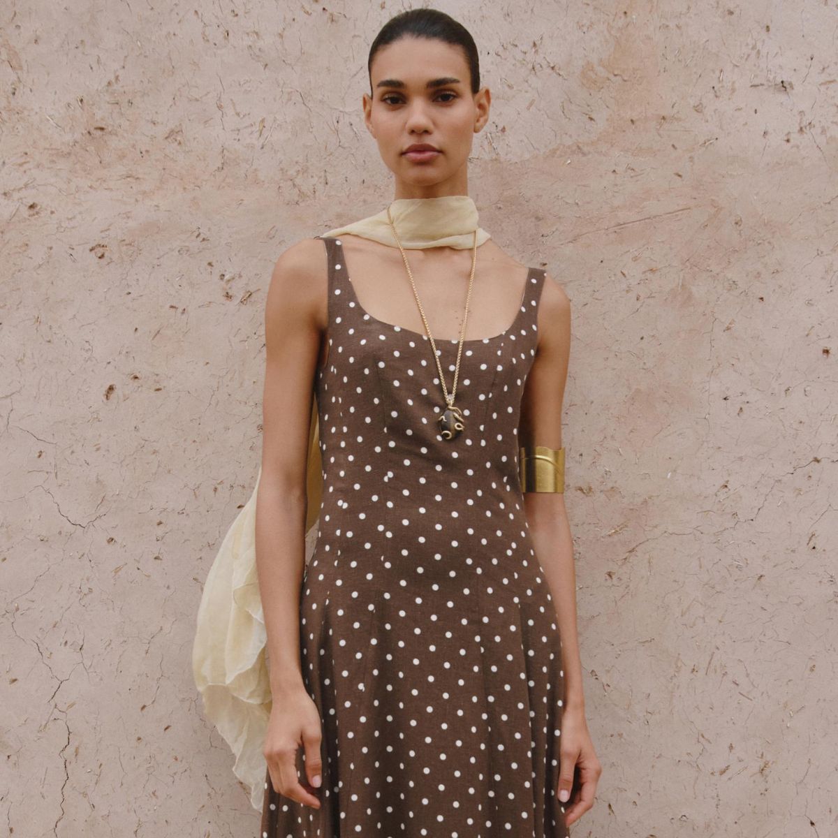 Woman wears buttery yellow dress