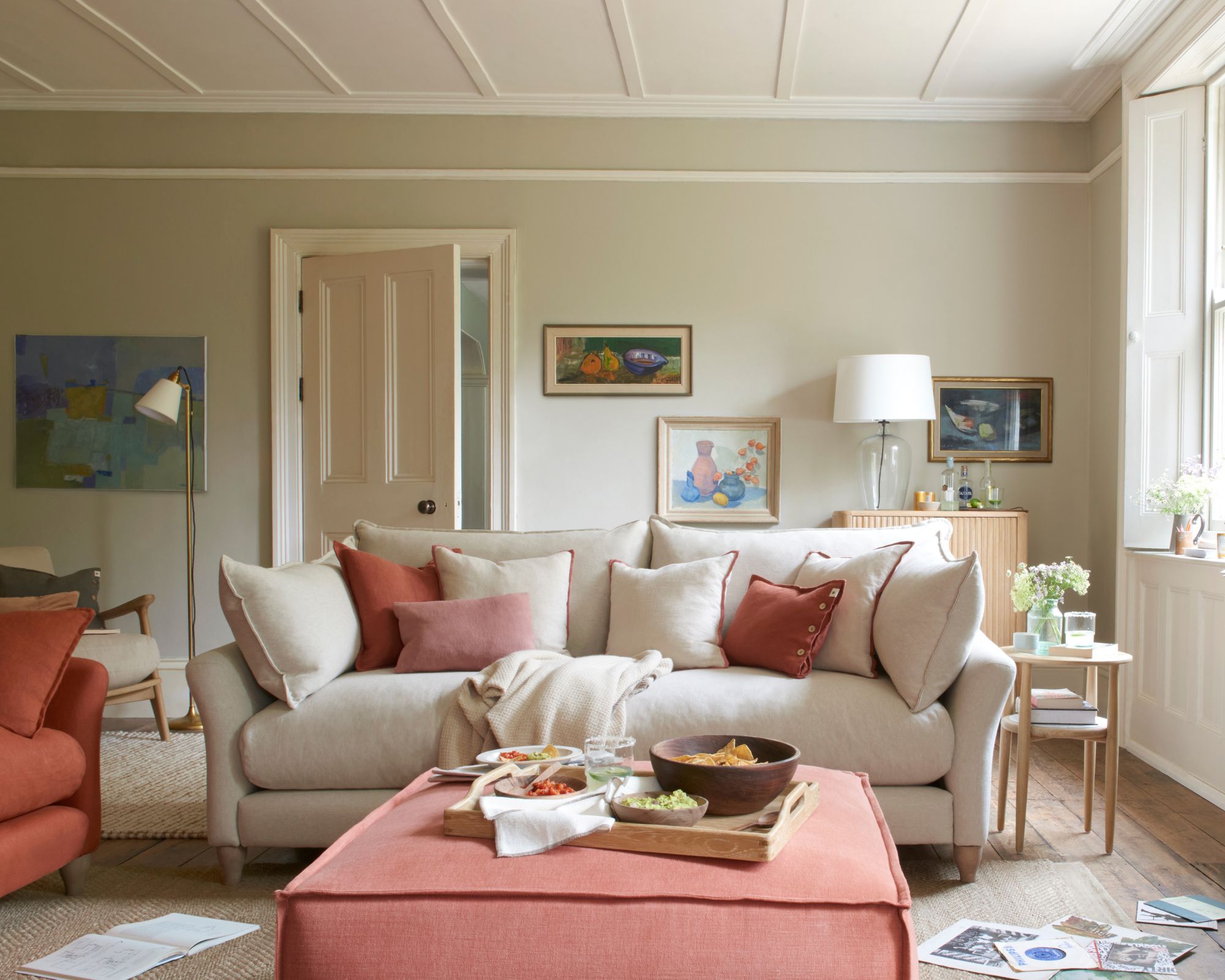 A cream sofa with scatter cushions in different terracotta shades