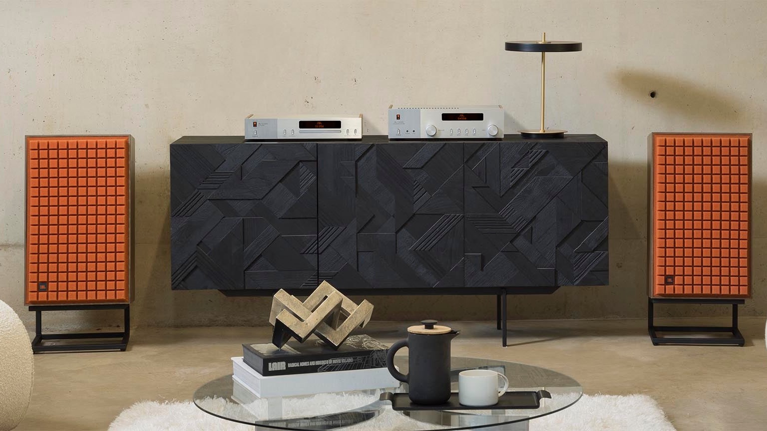 JBL L100 Classic MkII speakers with orange foam grille and hi-fi separates on cabinet