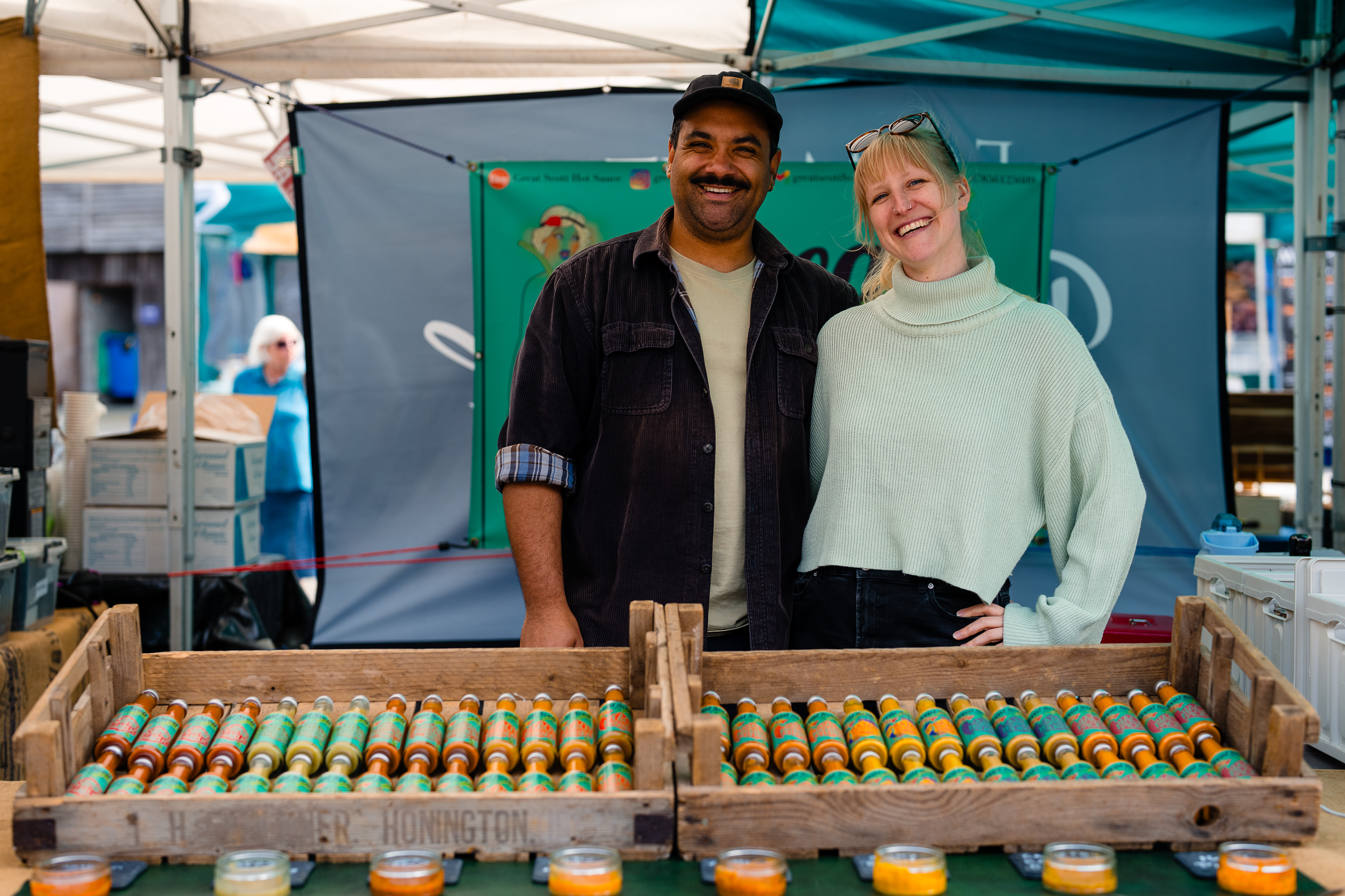 a man and a woman behind hot sauce