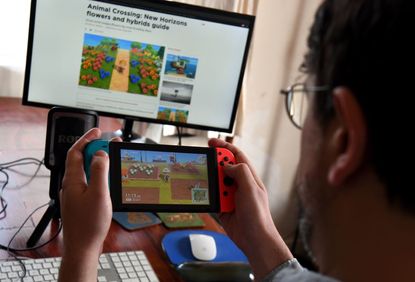 This photo taken on April 29, 2020 shows Australian high school teacher Dante Gabriele playing Nintendo's Animal Crossing at home in Melbourne during the country's enforced COVID-19 coronavir