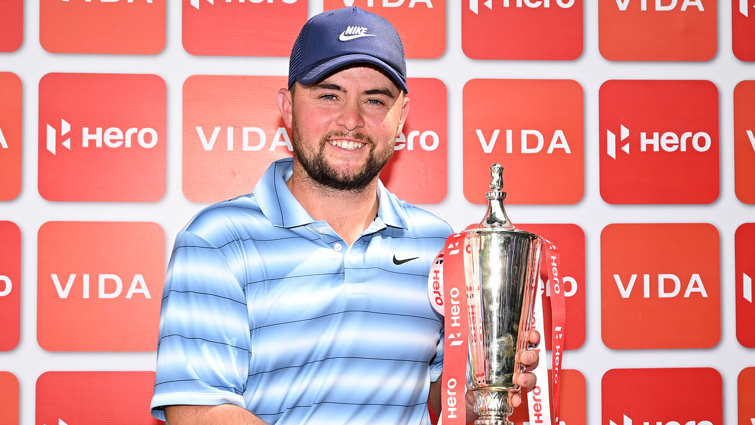 Alex Fitzpatrick poses for a photo with the Hero Indian Open trophy  