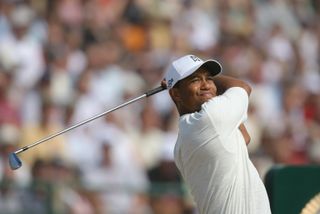 Tiger Woods holds his finish after hitting an iron shot