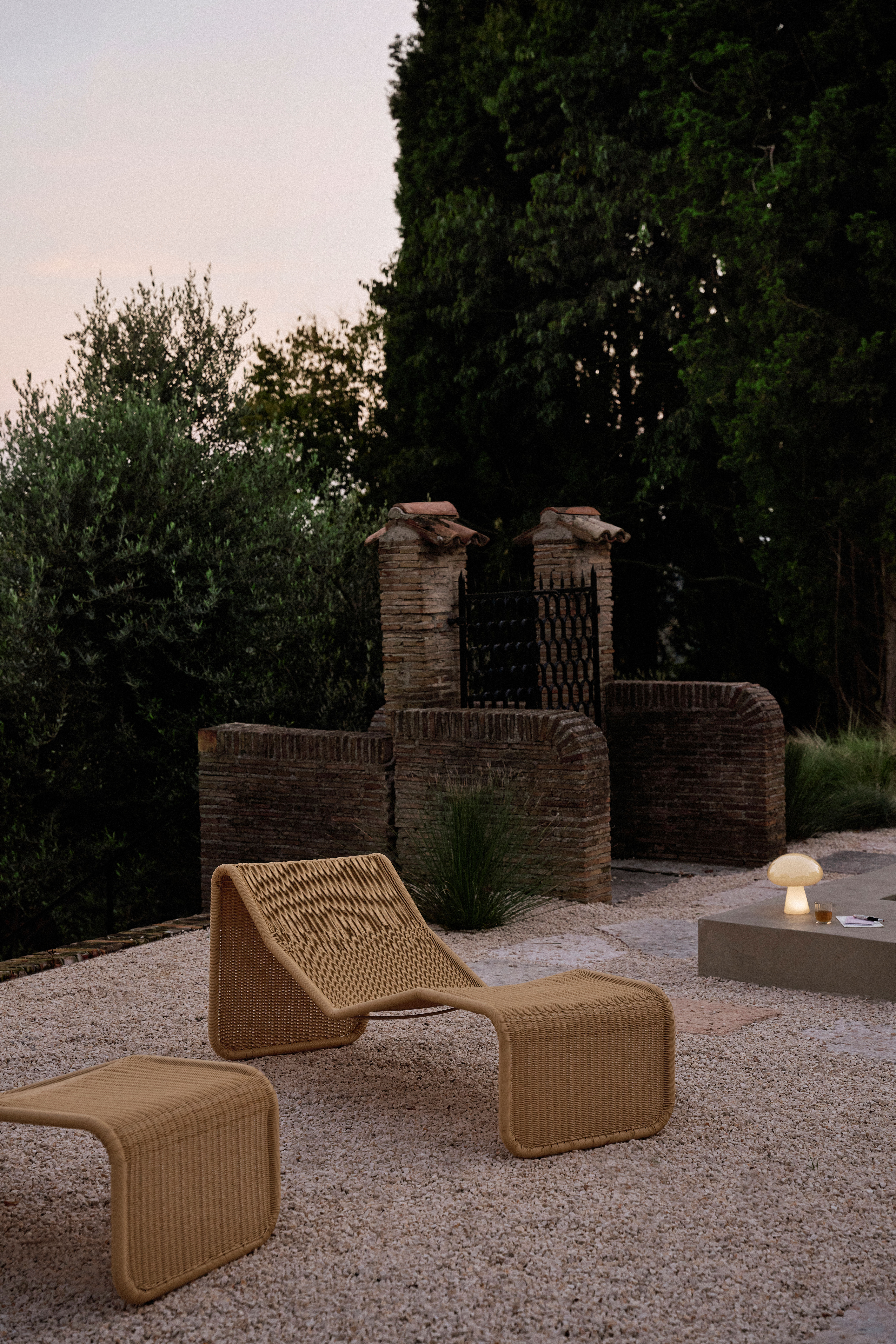 Rattan chairs by Gubi and Bonacina photographed poolside in a garden