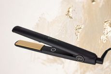 ghd straighteners on a gold and cream coloured background