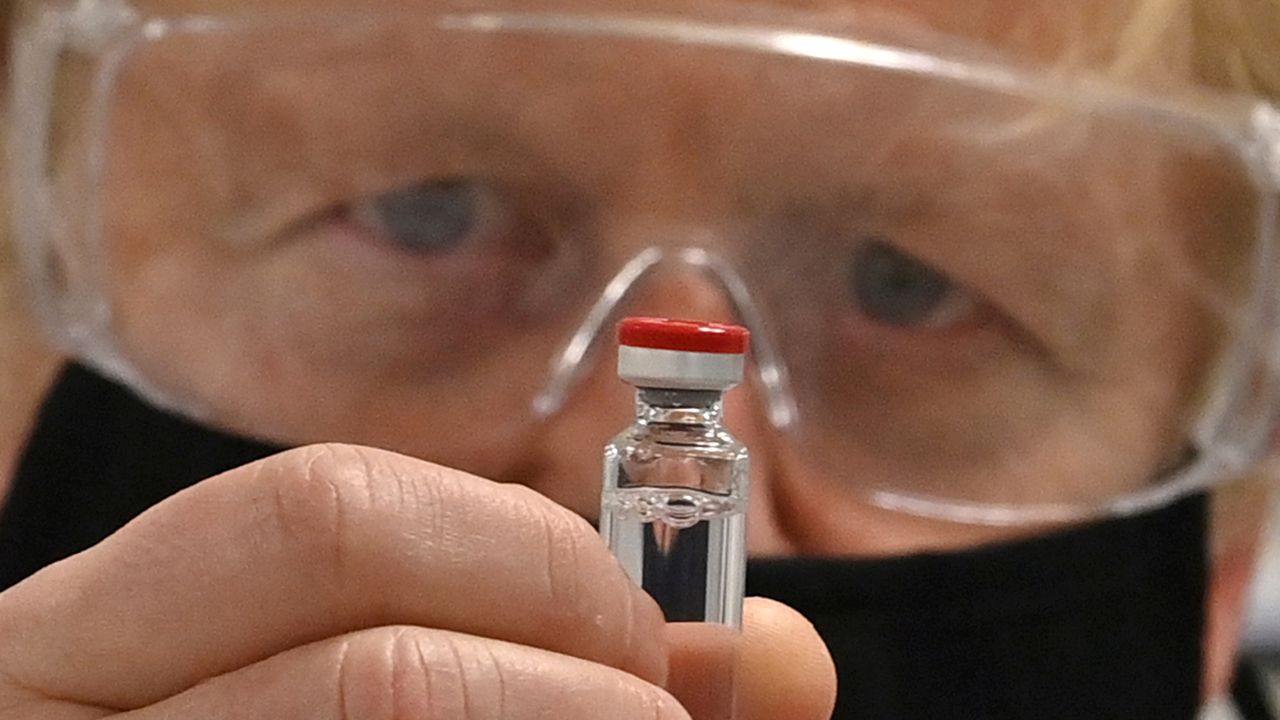 Boris Johnson with a vial of the AstraZeneca/Oxford University Covid-19 candidate