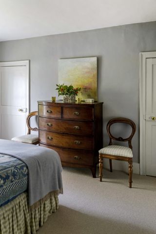 master bedroom with white door and wooden chair