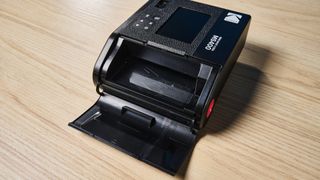 A black Kodak Mini Shot 4 Era 2-in-1 instant camera and printer