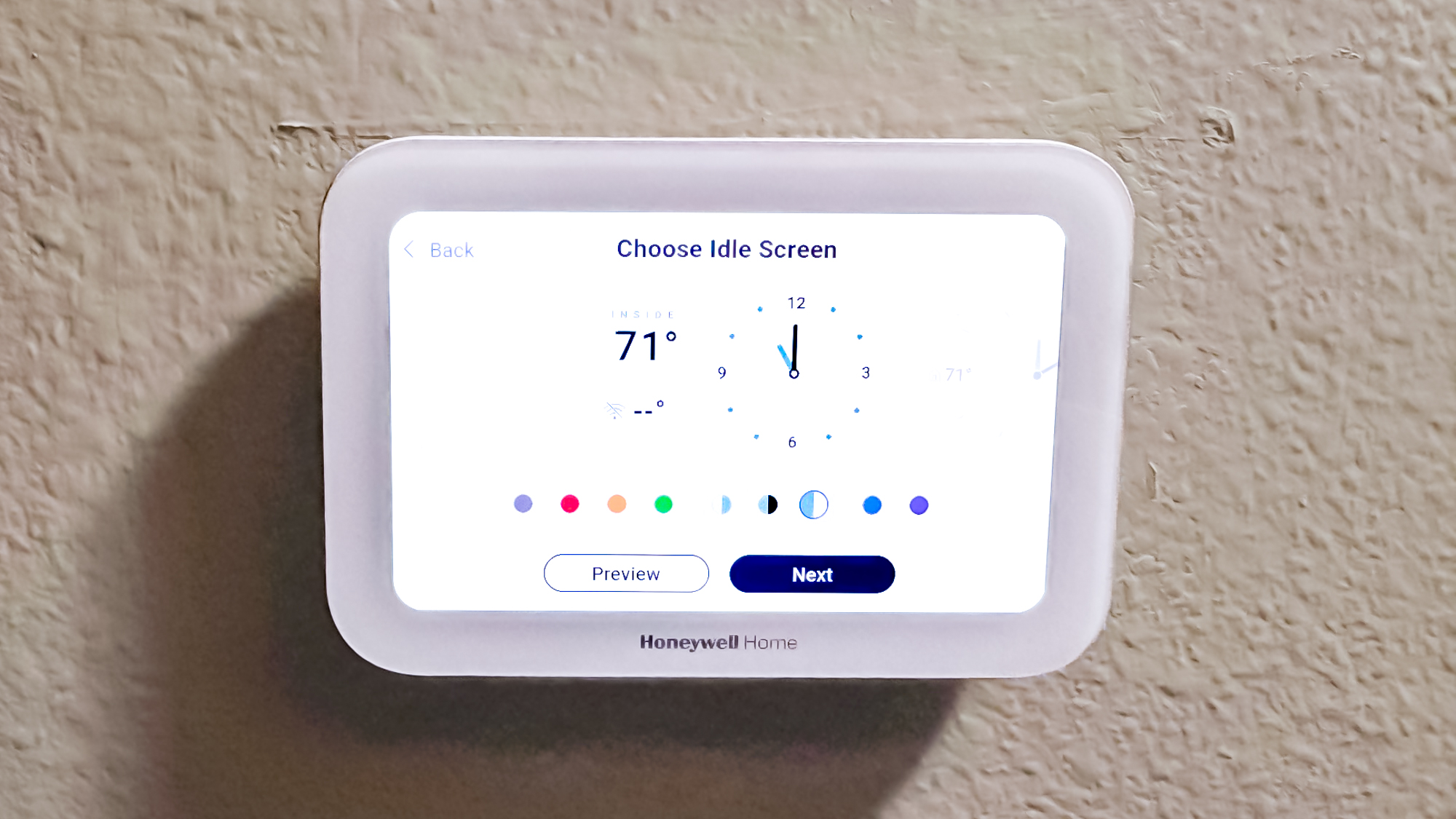 Honeywell Home X8S Smart Thermostat mounted to a hallway wall