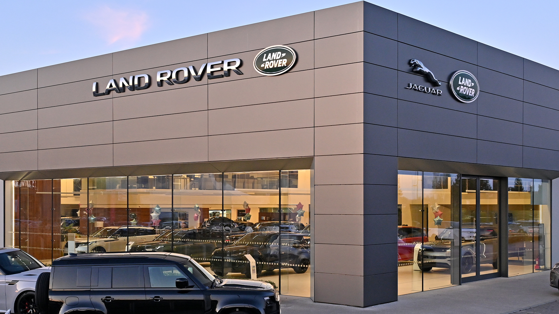 Jaguar Land Rover dealership with Land Rover and Jaguar logos on building facade.