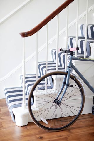 Decorating with stripes - A striped rug against an otherwise plain background is a powerful tool in interior architecture – it has the effect of redirecting the eye and reshaping a space - stairs with runner in stripes