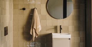Caramel light brown bathroom color trend 2023 on wall tiles and sink vanity unit