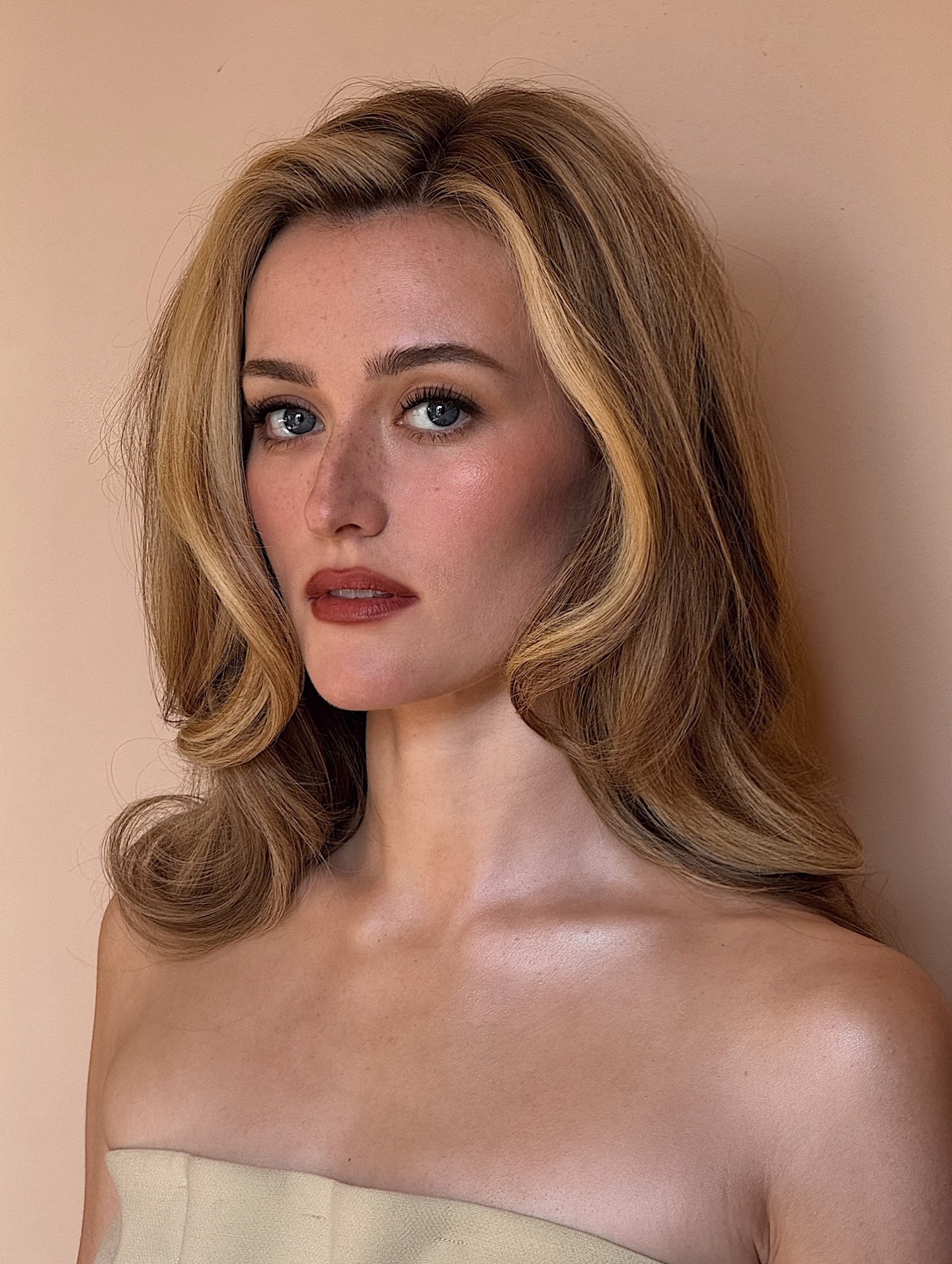 Sarah Pidgeon with a side-part, face-framing hairstyle