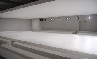 White room with black lighting racks