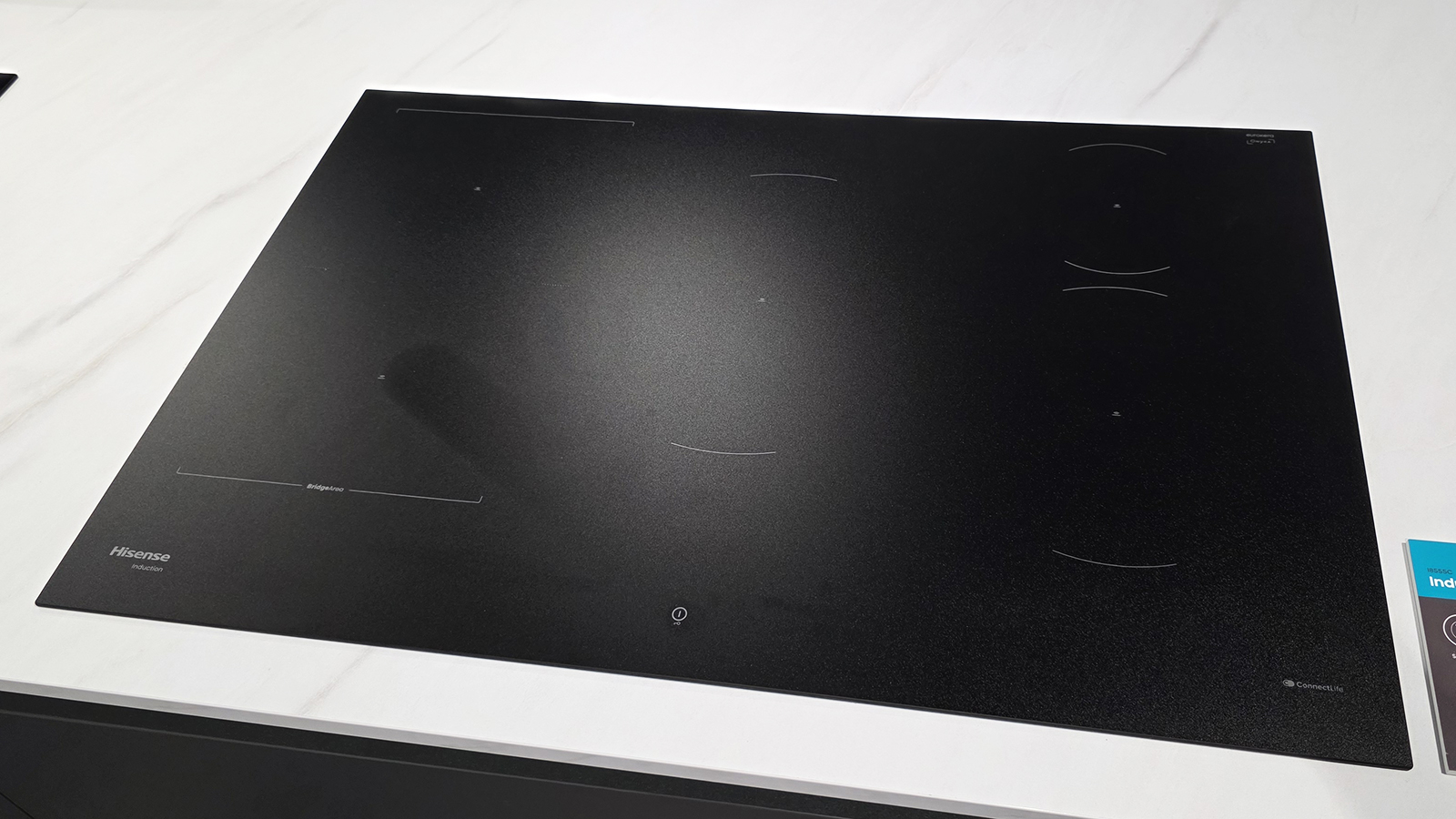 A black induction cooktop from Hisense on a kitchen countertop 