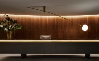 Dark American walnut wall panelling at Open plan living room of Francesc Macia 10 by Marcio Kogan
