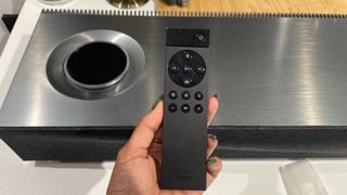 Naim Mu-so 2 with remote control in hand