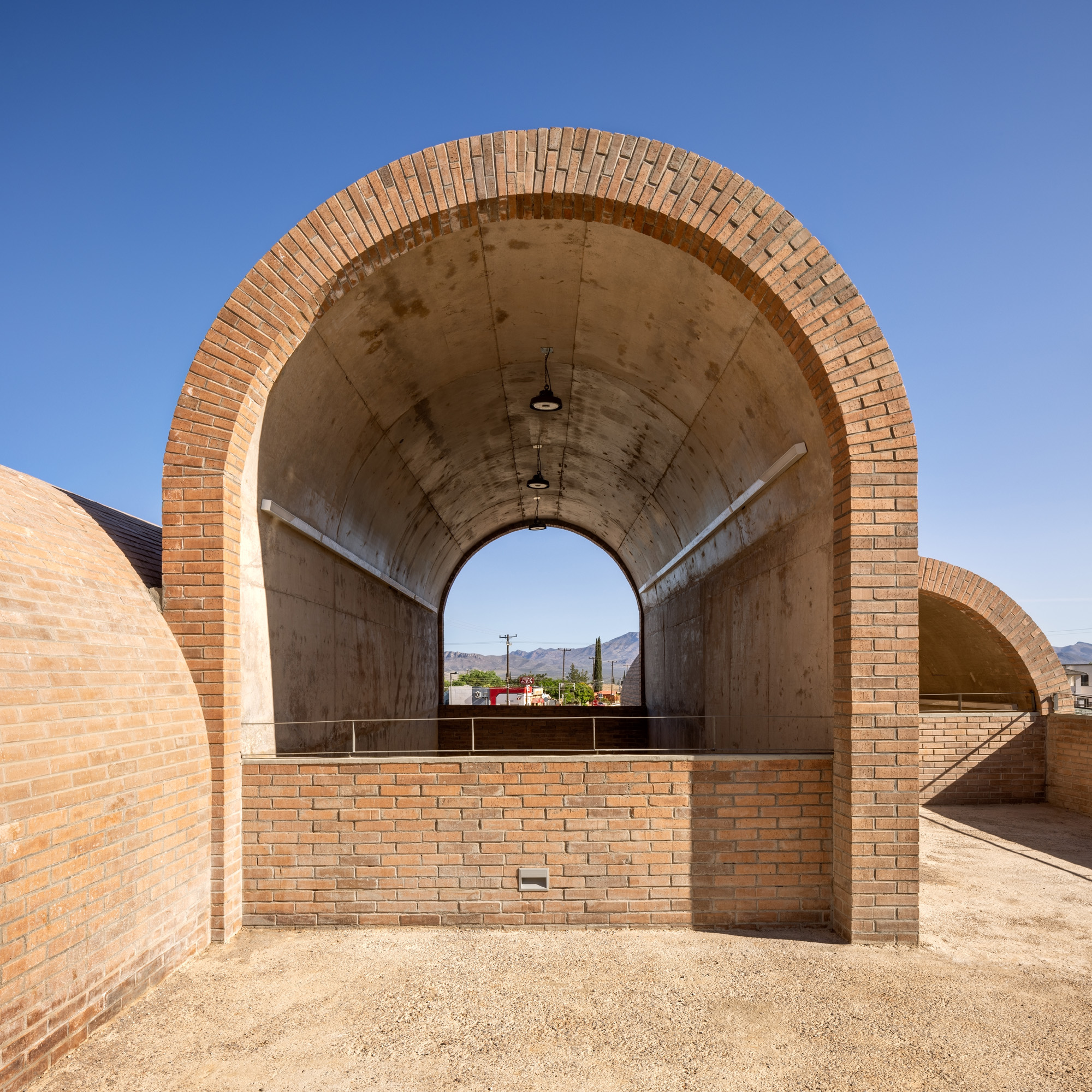 Border Outlook by Fernanda Canales, a brick, textured structure made of vaults and raised platforms