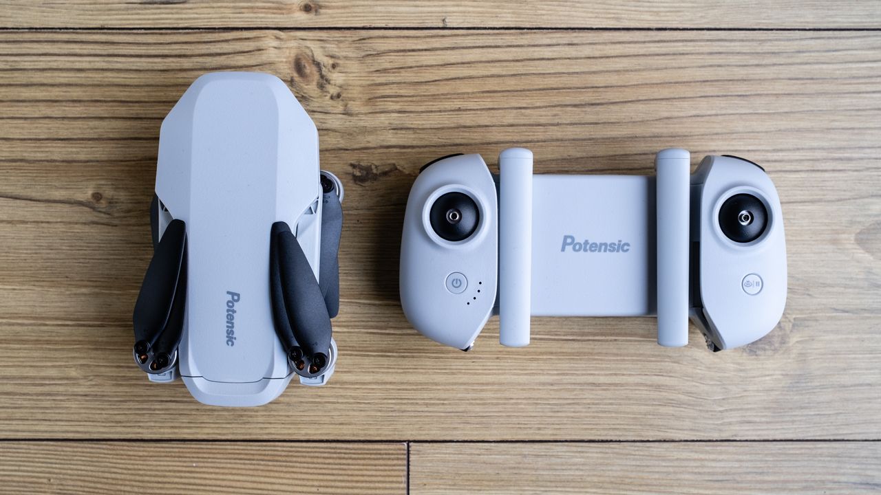 Potensic Atom SE drone and controller on a wooden floor