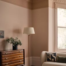 living room paint colours for 2023, plaster pink living room with darker plaster on coving, boucle sofa, floor lamp, vintage chest of drawers 