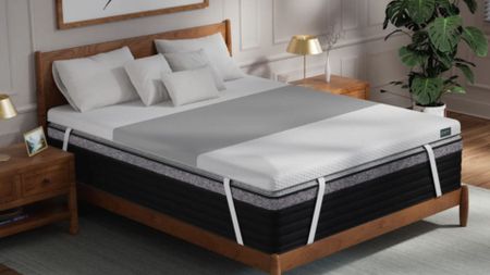 Helix ErgoAlign mattress topper on top of black mattress on wooden bedframe in bedroom with plant, gold bedside lamps and grey rug