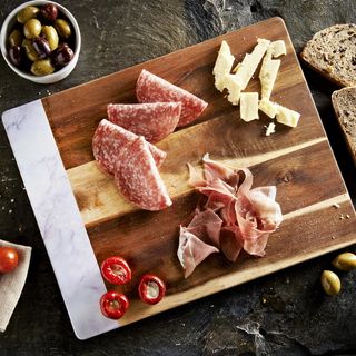 wooden chopping board with bread and meat