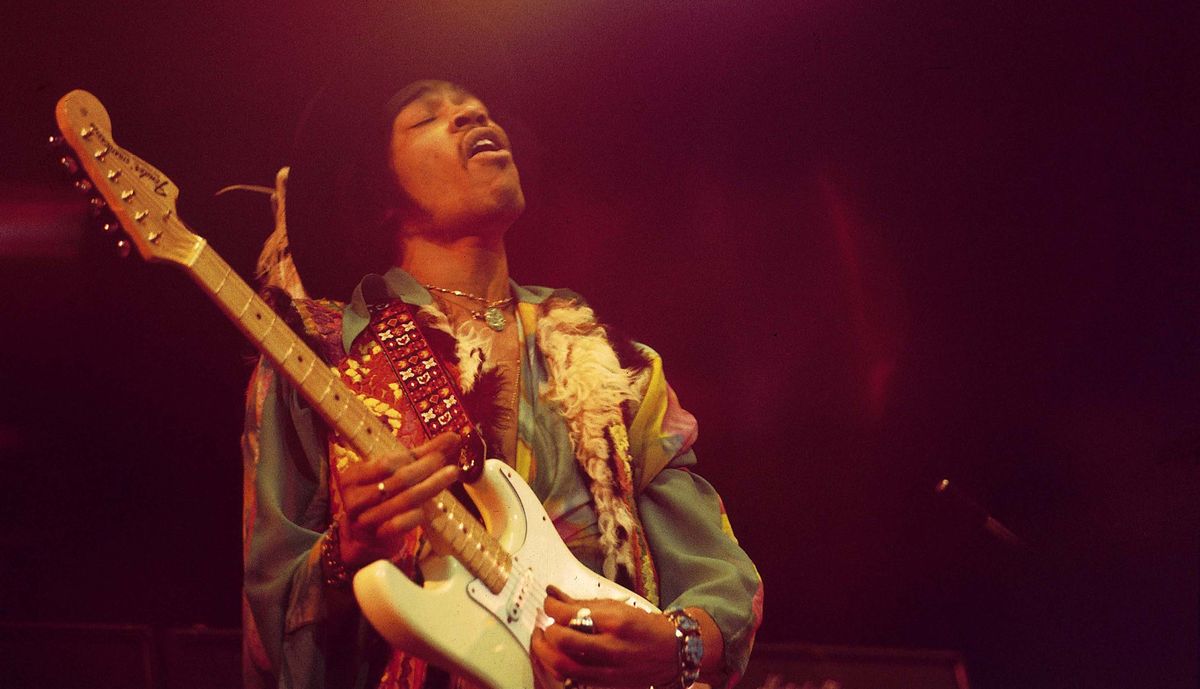 Jimi Hendrix performs live on stage playing a white Fender Stratocaster guitar with The Jimi Hendrix Experience at the Royal Albert Hall in London on 18th February 1969