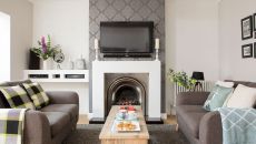 living room with white walls wallpaper and grey sofa.