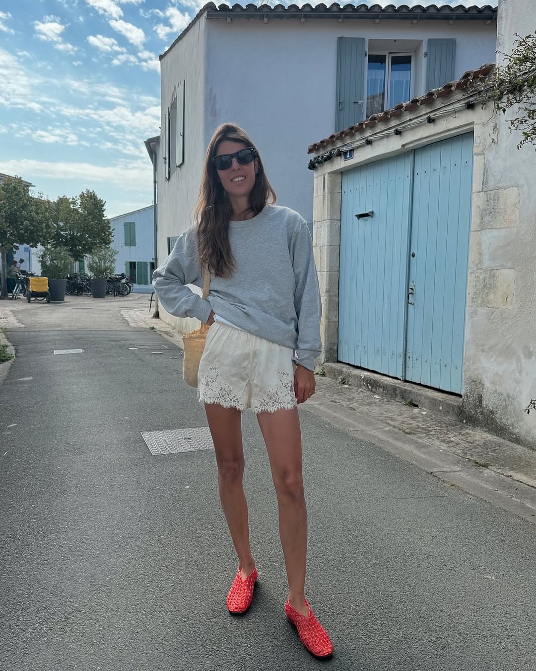 Laura Vidrequin wearing Doen lace silk shorts.