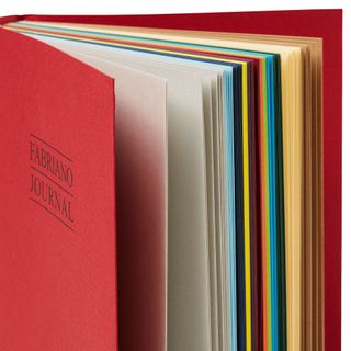 A red journal stands against a creme background.