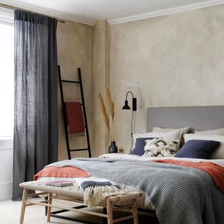 bedroom with black and macrame bench