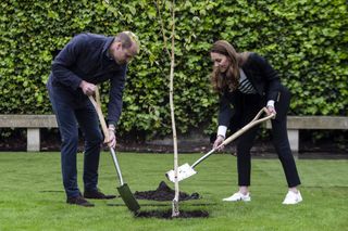 Prince William, Duke of Cambridge and Catherine, Duchess of Cambridge take part in planting a tree during a visit to the University of St Andrews on May 26, 2021 in St Andrews, Scotland.