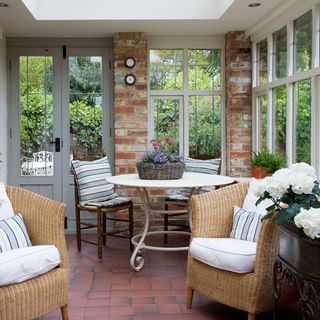 brick wall sitting area with wooden furniture