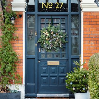 blue front door with Christmas wreath