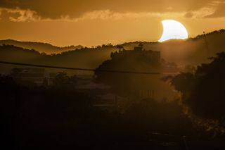 Photographer CJ Armitage of Brisbane, Australia captured this stunning view of the sunset solar eclipse on April 29, 2014 during the first solar eclipse of the year. A partial solar eclipse was visible from most of Australia during the event, with an annu