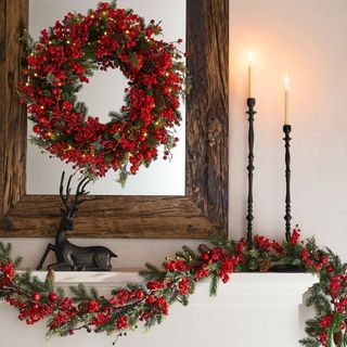 Faux Lit Mixed Berries Wreath & Garland on a white mantel.