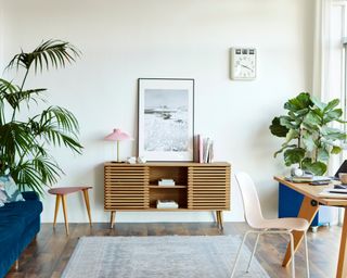 Computer at table in apartment. Bright modern room with furniture. Interior of home office.