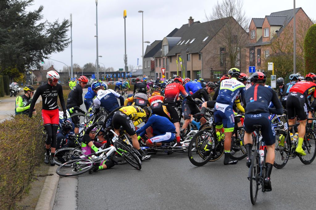 NOKERE BELGIUM MARCH 17 The peloton during the 75th Nokere Koerse Danilith Classic 2021 Mens Elite a 1955km race from Deinze to Nokere Crash Injury NokereKoerse on March 17 2021 in Nokere Belgium Photo by Luc ClaessenGetty Images