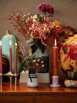 autumnal flowers, candles and pumpkins