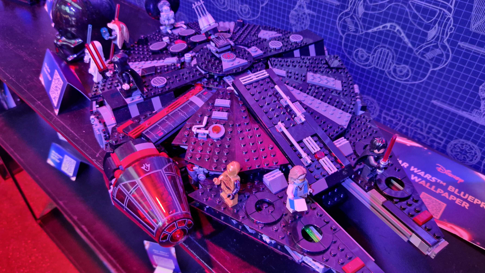 The Dark Falcon on a Star-Wars themed shelf, with minifigures on it