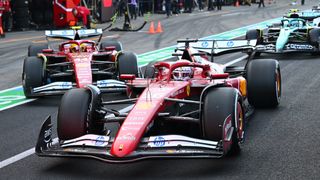 Lewis Hamilton and Charles Leclerc leaving the pit lane in their Ferrari's alongside Fernando Alonso (Aston Martin) as they prepare for the Emilia Romagna GP
