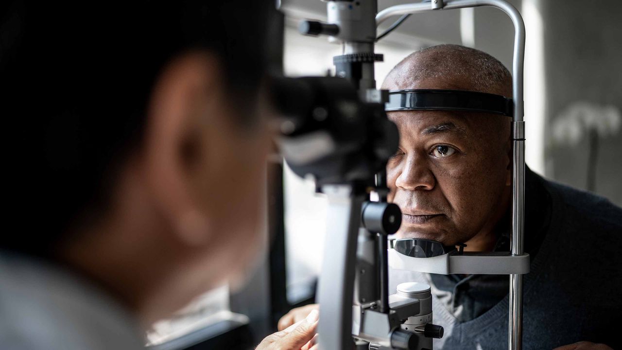 Ophthalmologist examining patient&amp;#039;s eyes