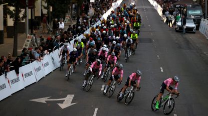 Image shows riders racing in a cycling crit race