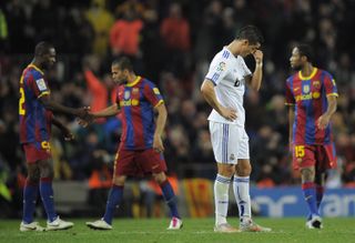 Cristiano Ronaldo looks dejected as Dani Alves and Eric Abidal celebrate Barcelona's fifth goal against Real Madrid at Camp Nou in November 2010.