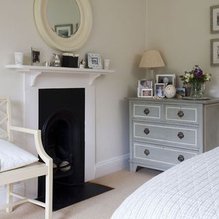 bedroom with fireplace and photoframe on white wall
