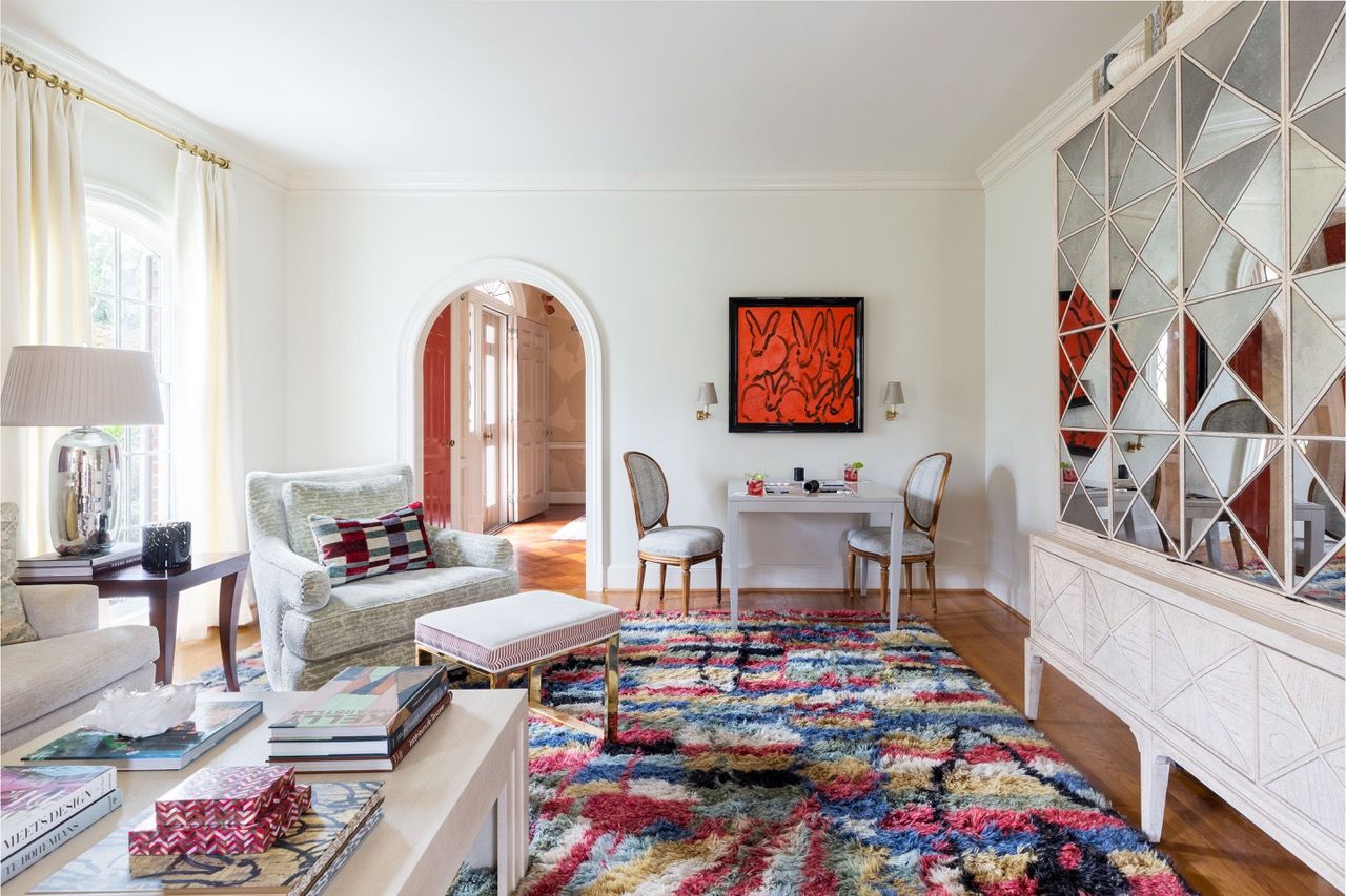 Living room with mirrored cabinet concealing TV