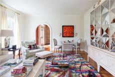 Living room with mirrored cabinet concealing TV