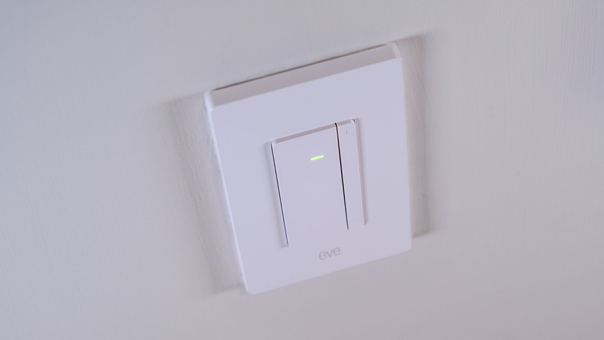 The Eve Dimmer Switch mounted on a white wall