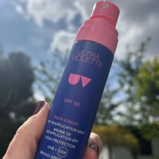 a bottle of ultra violette preen screen spf in front of a blue sky